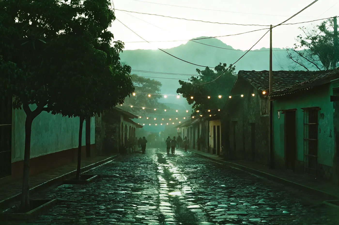 Misty El Salvador colonial street at dusk with string lights